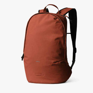 Bellroy rust colored backpack with black straps and zipper details