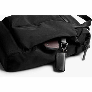 Bellroy black backpack with small leather accessories in the front pocket