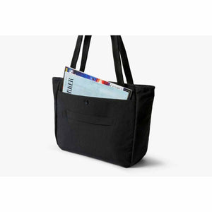 Bellroy black tote bag with a magazine in the outer pocket