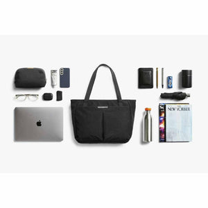 Bellroy black tote bag surrounded by organized daily carry items including a laptop, water bottle, and accessories