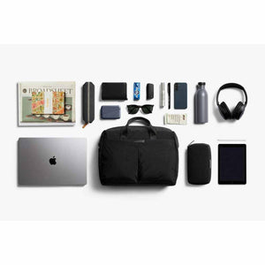Bellroy black bag surrounded by organized daily carry items including a laptop tablet headphones and accessories