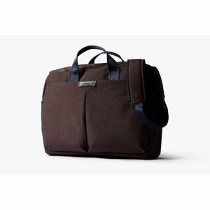 Bellroy brown briefcase with navy blue handles and shoulder strap