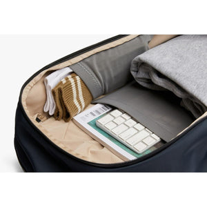 Open Bellroy bag interior with folded clothes and a keyboard