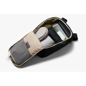 Open Bellroy backpack packed with clothing and accessories