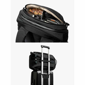 Bellroy backpack showing internal organization and luggage pass through strap attached to suitcase handle