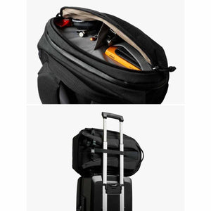 Bellroy backpack showing interior organization and luggage pass-through strap attached to suitcase handle