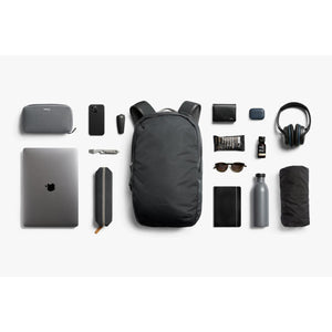 Bellroy backpack surrounded by organized daily carry items including laptop, headphones, and accessories