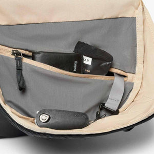 Interior of a Bellroy bag showing a zippered pocket with a wallet and snack bar plus a key clip