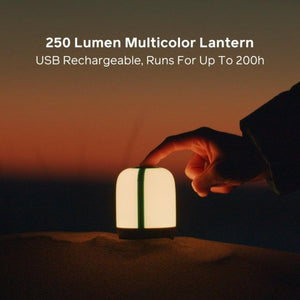 BioLite 250 lumen multicolor USB rechargeable lantern on sand with hand touching top