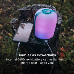 BioLite lantern charging a smartphone on a tree stump