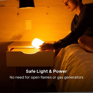 Person placing a glowing BioLite lantern into a bedside drawer