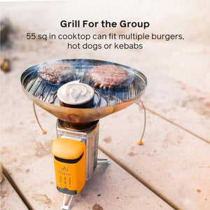 BioLite portable camp stove grilling two burger patties on a circular metal grate
