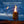BioLite camp stove with a lit flame and attached flexible LED FlexLight at night