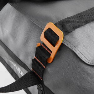 Orange metal buckle on a grey BioLite gear bag strap