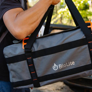 Person carrying a grey BioLite gear bag with black straps