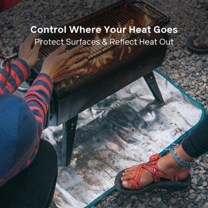 BioLite fire pit mat placed under a portable fire pit on gravel ground