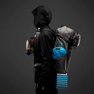 Person wearing a Black Diamond backpack with attached gear and accessories