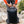 Person fastening the buckle on a Black Diamond backpack outdoors