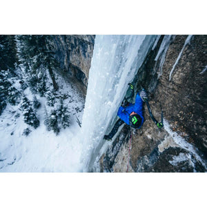 Climber using Black Diamond ice axes to ascend a frozen waterfall