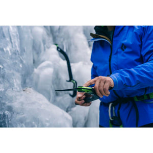 Climber holding Black Diamond ice tool against ice wall