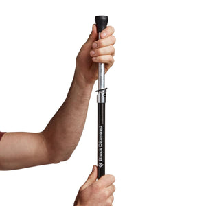 Hands adjusting the height of a Black Diamond trekking pole