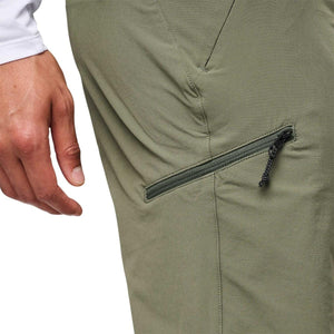 Close up of Black Diamond olive green hiking pants with zippered thigh pocket