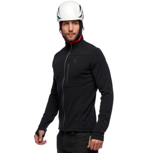Man wearing a black Black Diamond fleece jacket and a white climbing helmet