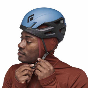 Person wearing a blue Black Diamond climbing helmet over a hooded base layer