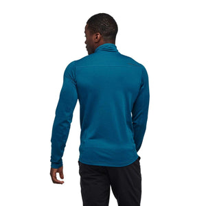 Back view of a man wearing a blue Black Diamond long sleeve quarter zip fleece