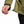 Hand adjusting the hem drawcord on a Black Diamond olive green jacket