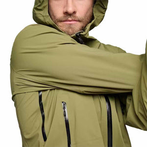 Man wearing olive green Black Diamond hooded jacket with black waterproof zippers