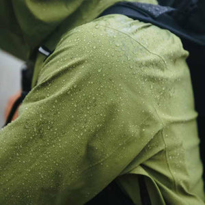 Water droplets on the shoulder of a green Black Diamond waterproof jacket