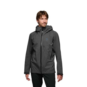 Man wearing a grey Black Diamond hooded shell jacket with black zippers