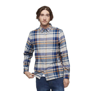 Man wearing a blue and tan plaid long sleeve button down shirt