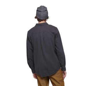 Back view of a person wearing a Black Diamond dark grey long sleeve button down shirt and a grey beanie