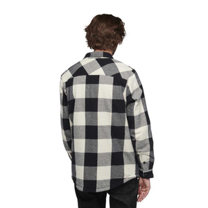 Back view of a person wearing a Black Diamond black and white buffalo plaid flannel shirt