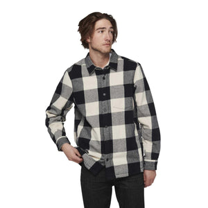 Man wearing a Black Diamond black and white buffalo plaid flannel shirt