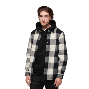 Man wearing a Black Diamond black and white plaid flannel shirt over a black hoodie