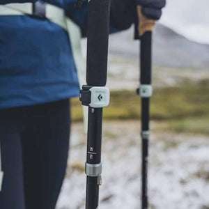 Black Diamond trekking poles with adjustable height markings held by a hiker