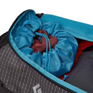 Black Diamond backpack interior with blue drawstring compartment and red clothing