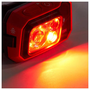 Black Diamond headlamp emitting a bright red light beam