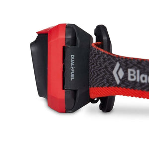 Black Diamond headlamp side view showing red and black casing with Dual Fuel text on the strap