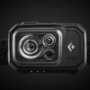 Black Diamond Storm R headlamp with three LED indicator lights on a black background