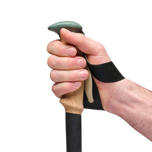 Hand gripping a Black Diamond trekking pole with a cork handle and black wrist strap