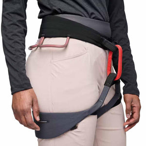 Black Diamond climbing harness worn over light pants