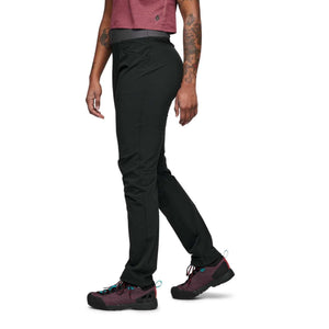 Side view of a person wearing Black Diamond black hiking pants and dark purple hiking shoes