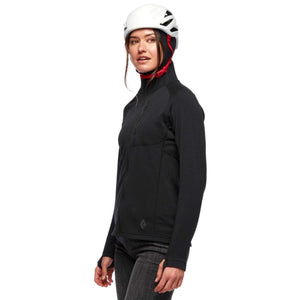 Woman wearing a black Black Diamond fleece jacket and a white climbing helmet