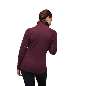 Back view of a person wearing a long sleeve burgundy quarter zip top