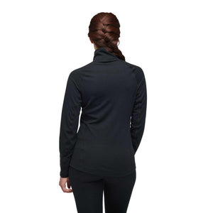 Back view of a woman wearing a black long sleeve base layer top