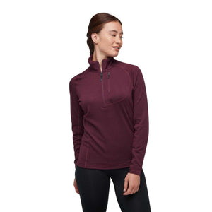 Woman wearing a maroon long sleeve quarter zip pullover